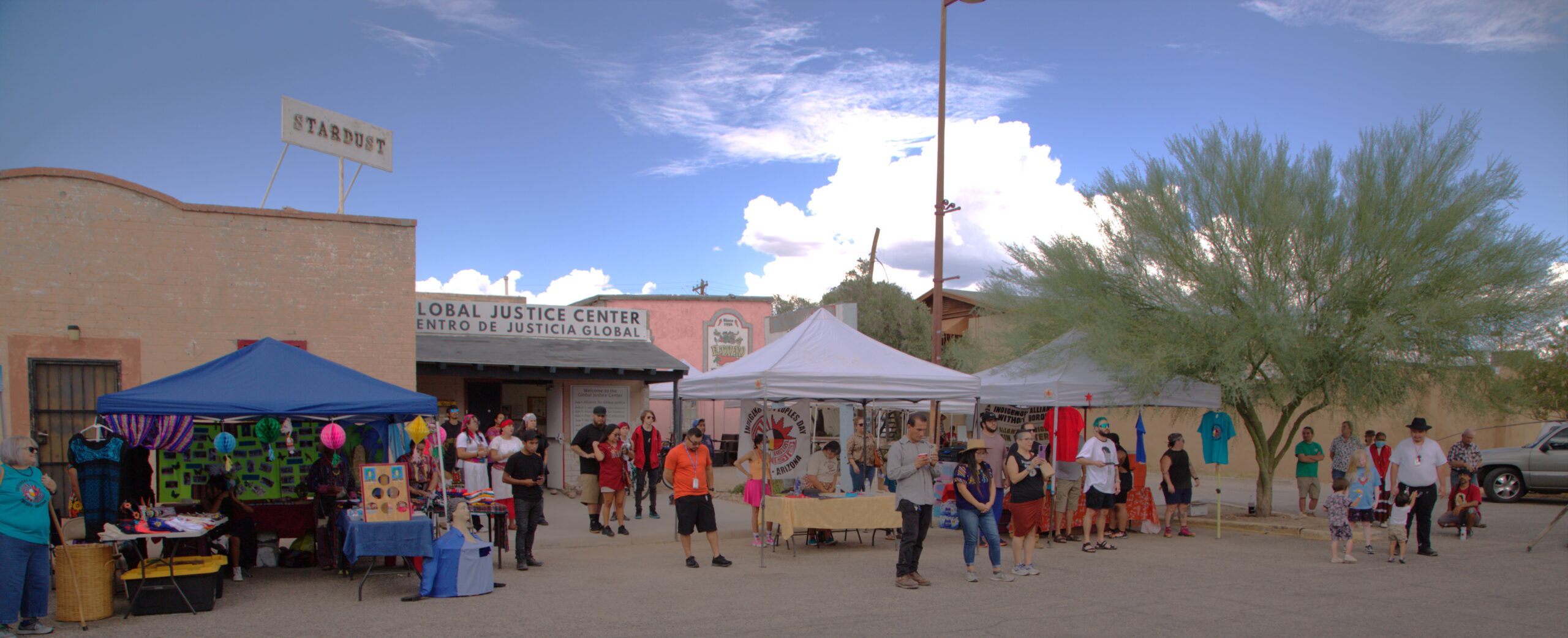 people standing around vendors tents